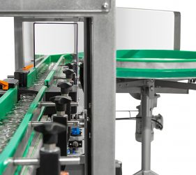 Glass bottles entering the cleaning carousel of the rotary rinser