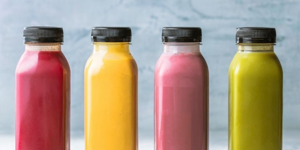 PET containers filled with juices and smoothies from a fruit and vegetable processing plant.